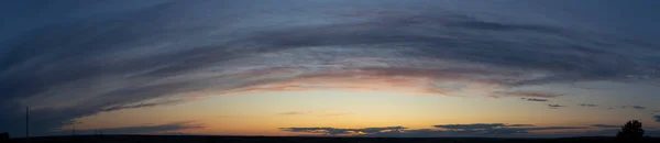 Epic landscape at sunset. Tragic gloomy sky. Fantastic skies on the planet earth. Crimson twilight. Panorama.