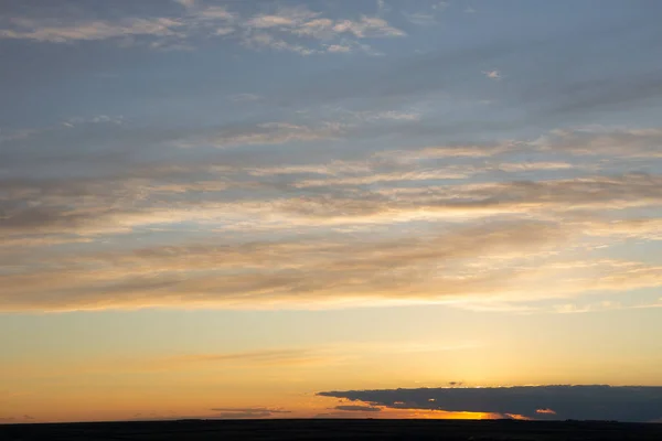 Epic landscape at sunset. Tragic gloomy sky. Fantastic skies on the planet earth. Crimson twilight. Panorama.