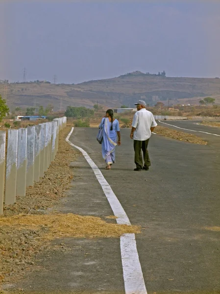 Adult couple walking on a bridge