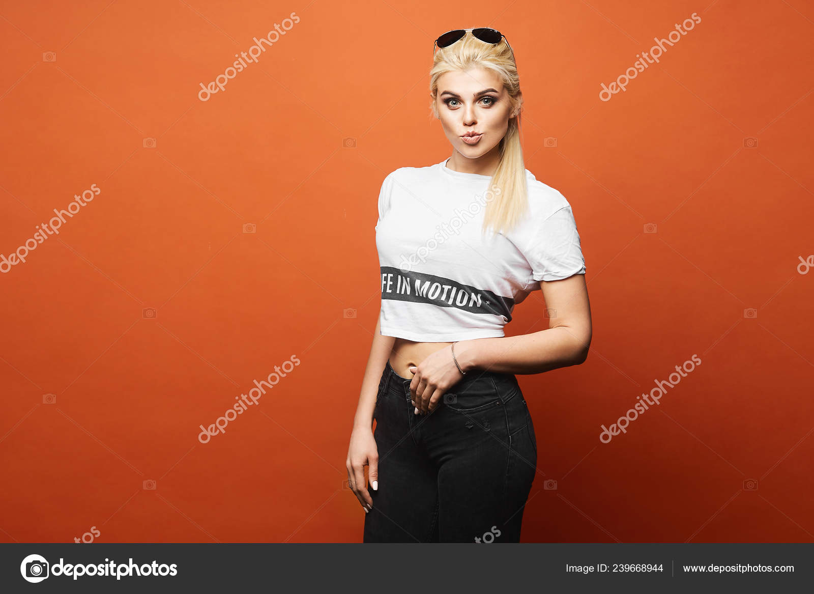 orange t shirt with black jeans