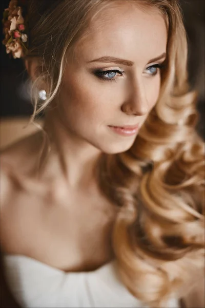 Young bride with beautiful blue eyes and with stylish wedding hairstyle — Stock Photo, Image