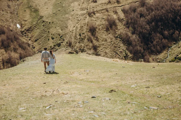 couple in love on the mountain watching the landscape