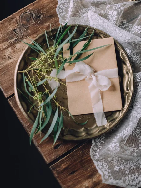 gift envelope with a pink ribbon decorated on a tray