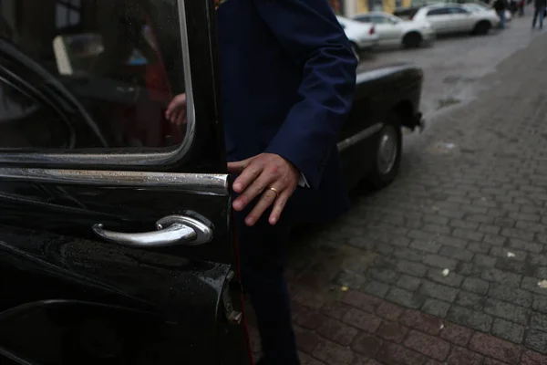 man in suit in retro car black driver rain