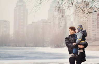 woman and child outside park lake winter ice snow fog clipart