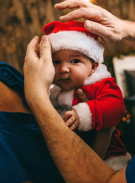 parents with baby for the holiday new year in santa suit