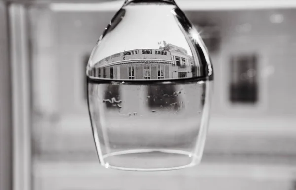 glass upside down with a mirror image of the building