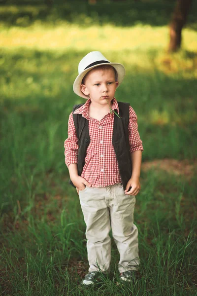 boy model with emotions in stylish clothes in spring outside is sunny