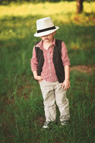 boy model with emotions in stylish clothes in spring outside is sunny