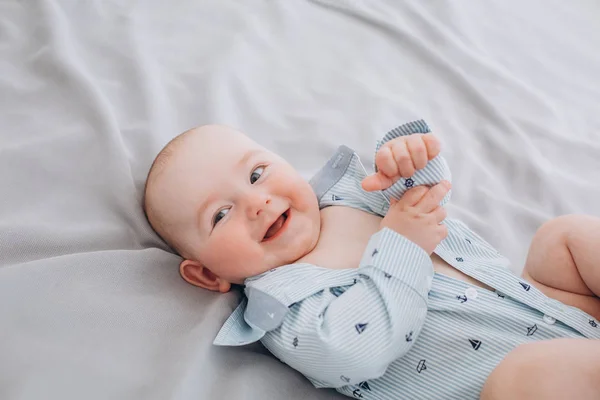 Laughter joy baby lies bed and emotions — Stock Photo, Image