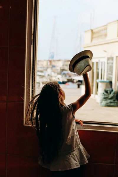 girl hat waves through window joy emotions
