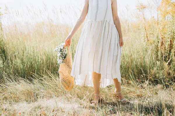 Mulher roupas naturais eco malha corda saco flores silvestres — Fotografia de Stock