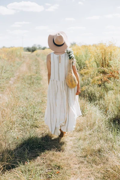 Mulher roupas naturais eco malha corda saco flores silvestres — Fotografia de Stock