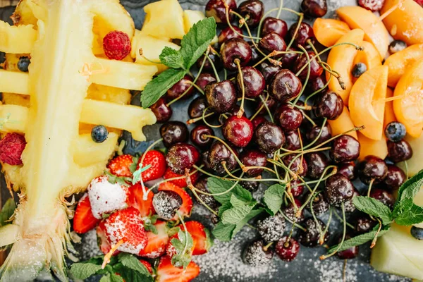 Variety tropical fruits tray sliced ������pineapple cherries — Stock Photo, Image