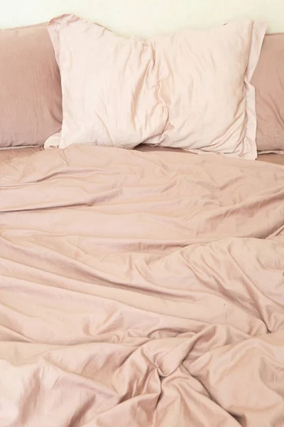 wrinkled sheet pillows and blanket on the bed home textile texture