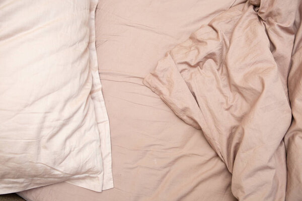 wrinkled sheet pillows and blanket on the bed home textile texture