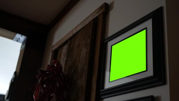 Un écran vert cadre photo noir accroché au mur de campagne 