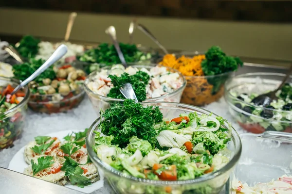 Greek food background. Greek salad, assortment of feta, olives and vegetables. Traditional greek dishes set.