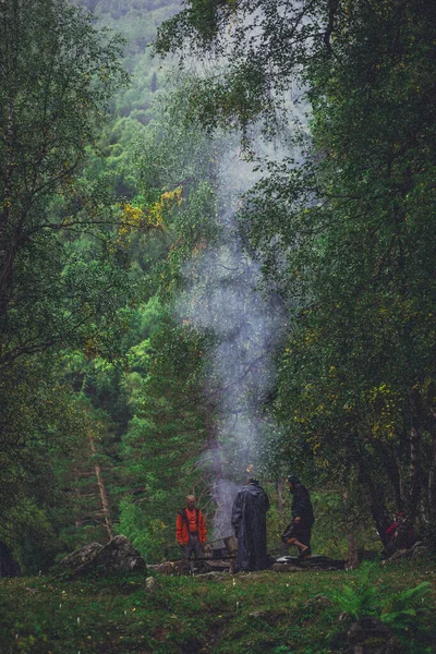 firecamp with three friends in the forest