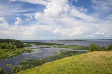 Panoramik nehir, çayırlar ve bulutlar