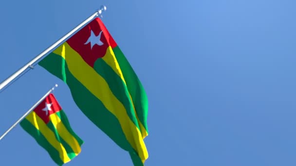 The national flag of Togo flutters in the wind against a blue sky — Stock Video