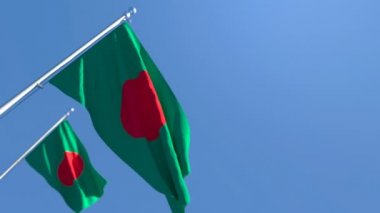 Bangladeş 'in ulusal bayrağı mavi gökyüzüne karşı rüzgarda dalgalanıyor.