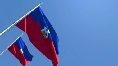 Haiti 'nin ulusal bayrağı mavi gökyüzüne karşı rüzgarda dalgalanıyor.