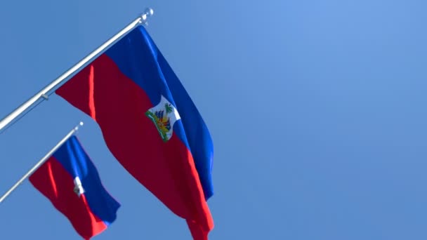 The national flag of Haiti is flying in the wind against a blue sky — Stock Video