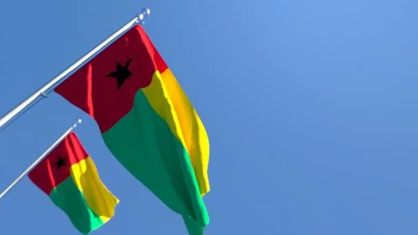 La bandera nacional de Guinea Bissau ondea en el viento contra un cielo azul — Vídeo de stock