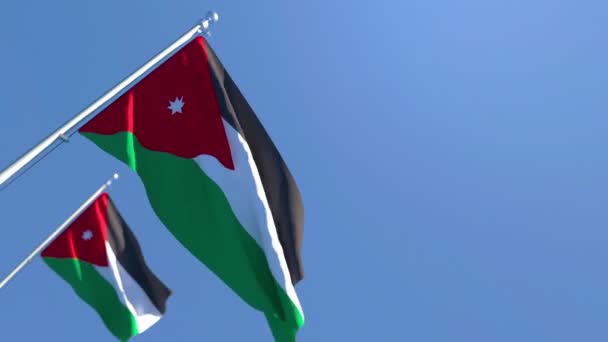 Jordánia nemzeti zászlaja a szélben repül a kék ég ellen. — Stock videók