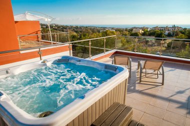 Jacuzzi on the roof of the house in the open air. clipart