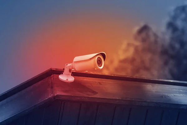 cctv security camera with building on blue sky background