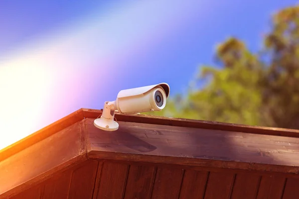 cctv security camera with building on blue sky background