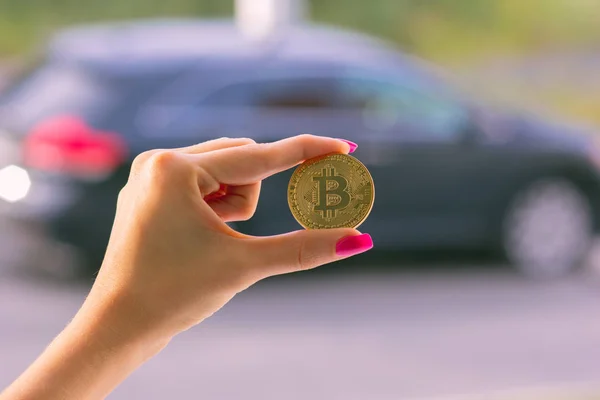 Female Hand Holds One Bitcoin Blurry Background Car — Stock Photo, Image