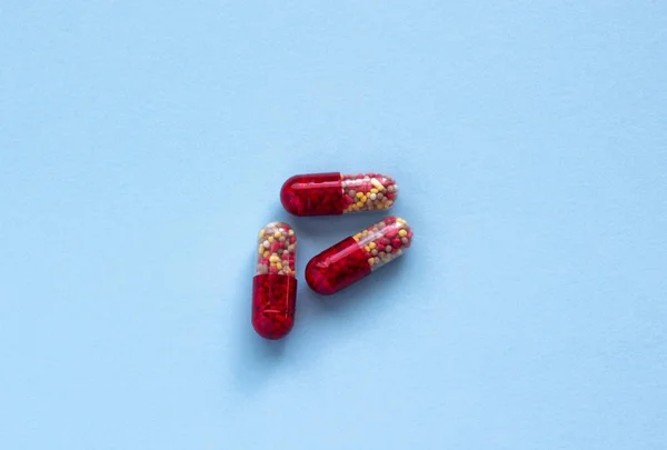 青い背景の赤と黄色の錠剤クローズ アップ — ストック写真