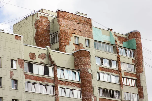 Old brick residential building with collapsing walls