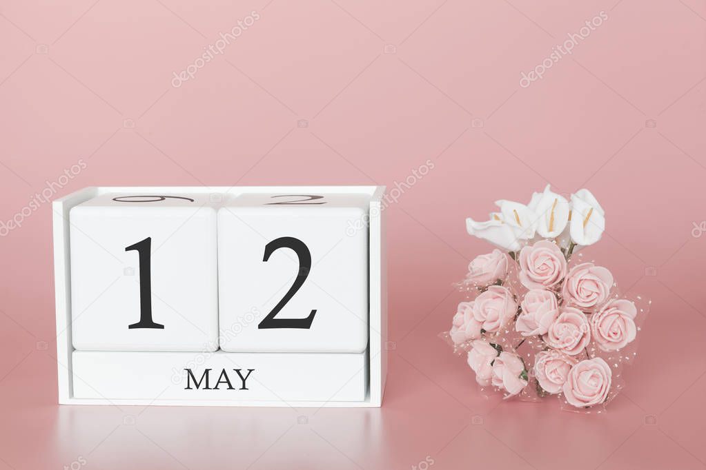 May 12th. Day 12 of month. Calendar cube on modern pink background, concept of bussines and an importent event.