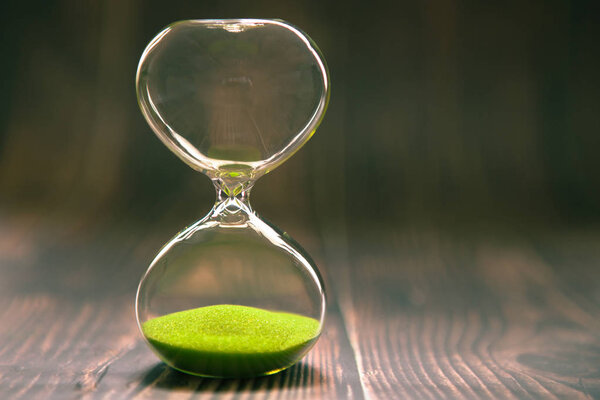 Hourglass as time passing concept for business deadline, urgency and running out of time.
