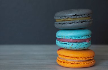 Koyu bir arka plan yakın çekim renkli macaroons, tatil için bir tedavi olarak Fransız çerezleri