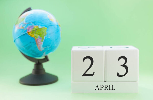 Planner wooden cube with numbers, 23 day of the month of April, spring