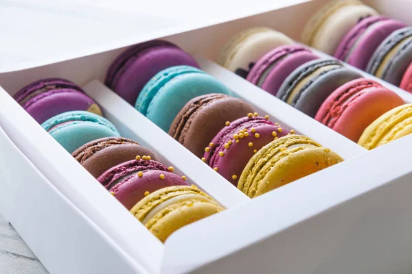 Colorful macaroons in a gift box on white table. — Stock Photo, Image