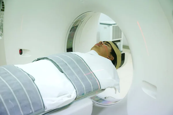 Electrocardiogram in hospital CT Scan room. heart rate monitor in hospital. Process of CT scanning of an old patient. Man Receiving a Medical Scan for a Trauma