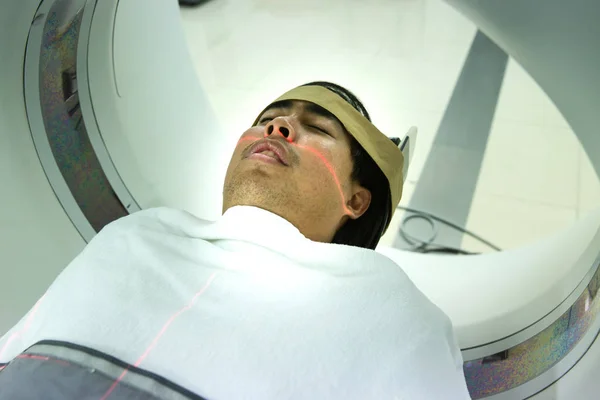 Electrocardiogram in hospital CT Scan room. heart rate monitor in hospital. Process of CT scanning of an old patient. Man Receiving a Medical Scan for a Trauma