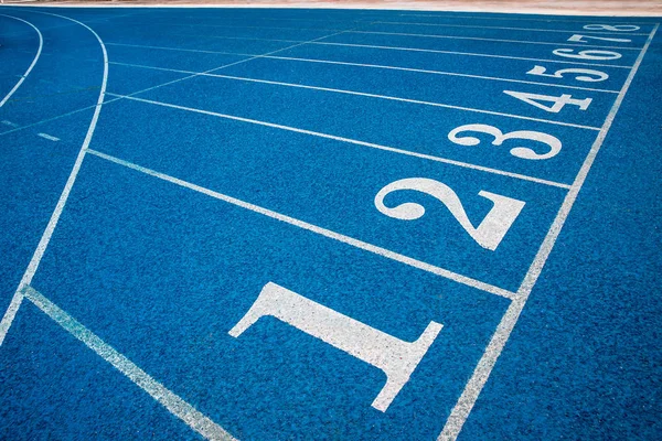 Running track with number. Blue running track in stadium. rubber running tracks in outdoor stadium.
