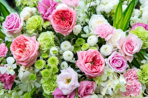 Beautiful flowers background for wedding scene. beautiful bouquet of mixed flowers in a vase on wooden table. the work of the florist at a flower shop. a bright mix of flowers.