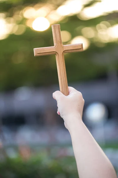 Person palm hands to hold holy cross, crucifix to worship. christian in catholic Eucharist bless god ceremony. People and religion concept. image for sign and symbol, background, objects, illustration