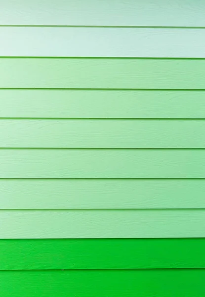 Wood green background.green Synthetic wood wall texture use for background.Colorful wooden board painted in green. Wood background