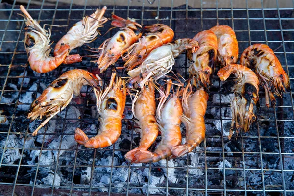 Prawns or shrimp grilled on charcoal stove. shrimp grilled bbq seafood on stove.Closed up river prawn charcoal grilled on stove with Thai style homemade.