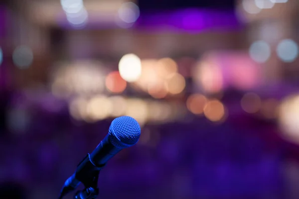 microphone in concert hall or conference room soft and blur style for background.Microphone over the Abstract blurred photo of conference hall or seminar room background.