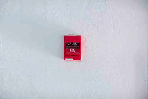 Fire alarm box on cement wall for warning and security system in the condominium place. standard safety in the resident, shopping mall and public place concept. image for copy space, background.